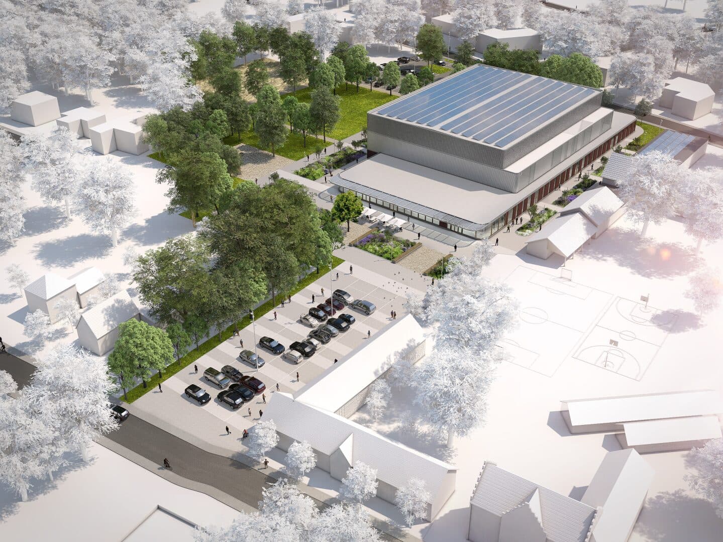 Luchtperspectief van de sporthal met zonnepanelen op het dak, tussen bomen en sportvelden